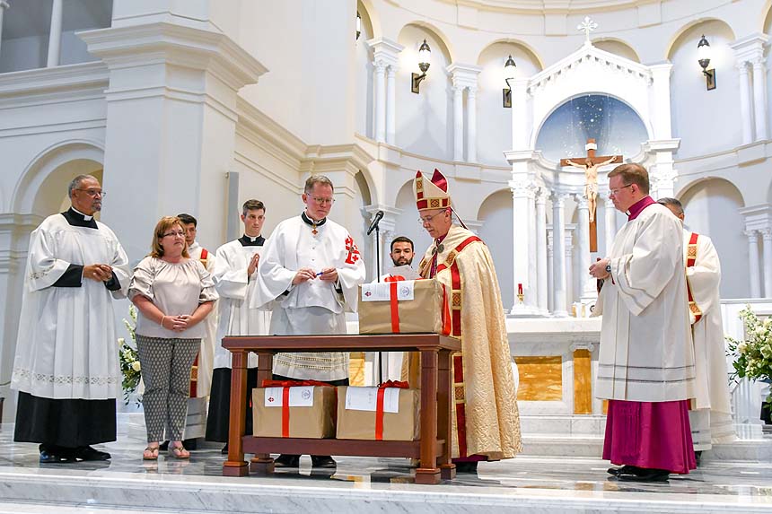 Notary Angela Page (second from left) and Father Jim Garneau (fifth from left) participate in the closing of the cause.