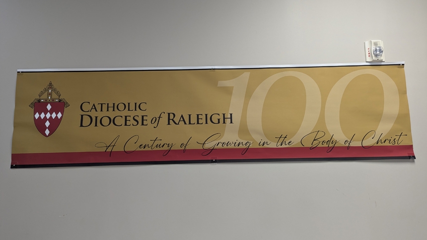 A centennial banner hangs in the parish hall at St. Matthew in Durham. 