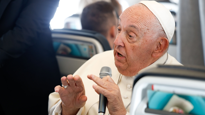 Pope Francis answers a question from a journalist aboard his flight back to Rome Sept. 29, 2024, after visiting Luxembourg and Belgium during his 46th international trip. (CNS photo/Lola Gomez)