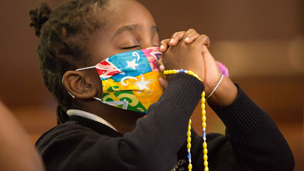 Anabel Mutune, a third grader at Transfiguration Catholic School in Oakdale, Minn., prays during a Children's Rosary Pilgrimage at Transfiguration Church in this Oct. 7, 2020, file photo. Pope Francis has called for a global prayer marathon during the Marian month of May to petition God for an end to the COVID-19 pandemic. (CNS photo/Dave Hrbacek, The Catholic Spirit)