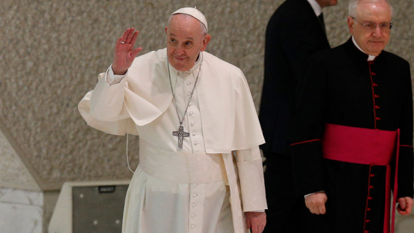 Pope Francis greets the crowd as he arrives to lead his general audience in the Paul VI hall at the Vatican Jan. 19, 2022. Also pictured is Msgr. Leonardo Sapienza, an official of the Prefecture of the Papal Household. (CNS photo/Paul Haring)